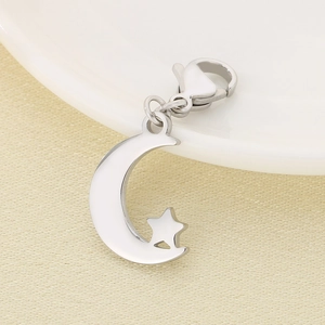 Macro view of silver stainless steel moon and star pendant with lobster clasp attachment