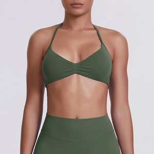 Detail of olive green halter sports bra and high-waisted leggings with matte texture