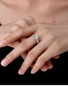 Detailed view of 1-carat moissanite ring with classic six-prong silver setting on finger