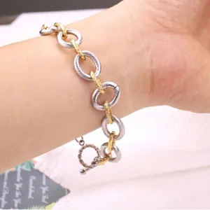 Two-tone titanium steel textured chain bracelet with spiral pattern and toggle clasp