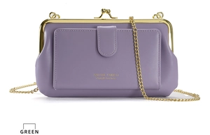 Detail view of purple PU leather cross body bag with golden chain strap and kiss lock clasp