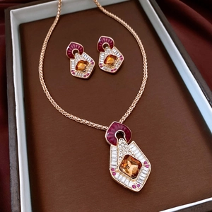 Close-up of vintage geometric gold jewelry set with diamonds in a premium gift box