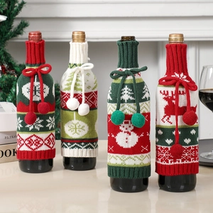 Detail of four knitted Christmas wine bottle bags with snowman and reindeer patterns