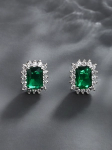 Detailed macro view of retro square emerald-cut green zircon earrings in silver setting