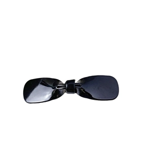 Elegant black acetate bow hair clip for women with a glossy finish on white background