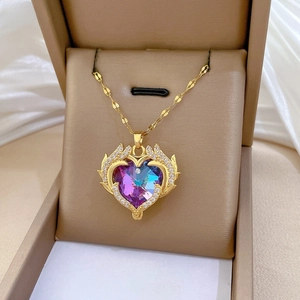Close-up of heart pendant necklace with purple gradient crystal and gold wings in gift box