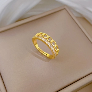 Macro shot of gold double-layer chain ring with micro-pave stones on a velvet box