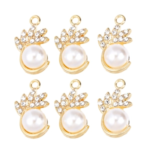 Detailed view of six golden pineapple charms with pearls and sparkling rhinestones