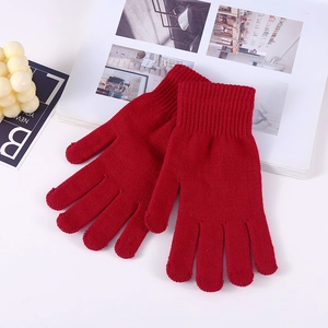 Red thermal knitted gloves for winter with elastic acrylic fabric on white background