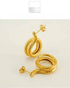 Detailed close-up showing the golden snake earrings with realistic scale texture finish