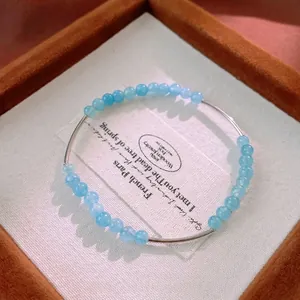 Elegant aquamarine beaded bracelet with polished silver metal tubes in a jewelry box