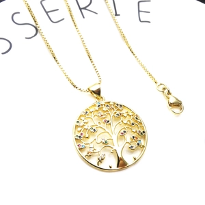 Detailed macro view of a gold-plated Tree of Life pendant necklace with multicolor zircon