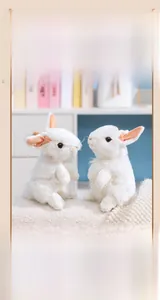 Close-up of two realistic white standing plush rabbits with soft fur and pink ears