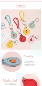 Detail of colorful fruit-themed PU leather keychains with secure stitching and metal clips