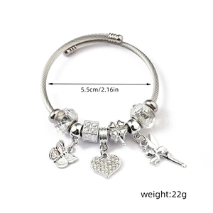 Detailed view of silver charm bracelet with butterfly heart and fairy charms on cable wire