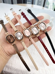 Close-up of small square women's quartz watches with leather straps in multiple colors