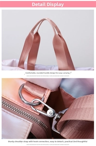 Detail view of the wide pink handles and durable silver metal hooks of this fitness bag