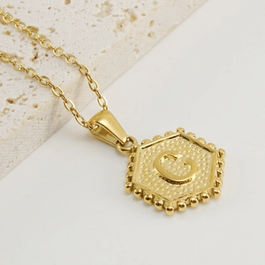 Golden hexagonal stainless steel necklace featuring embossed letter C pendant for women