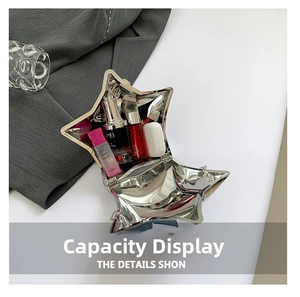 Capacity view of silver star-shaped clutch bag holding lipstick and wireless earphones