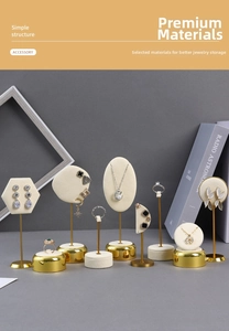 Detail of jewelry display set with cream velvet panels and gold metal frames