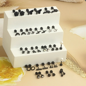 Set of black stainless steel piercing earrings with butterfly flower and star motifs