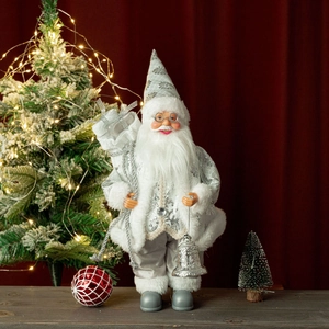 Detail of silver and white Santa Claus figurine with embroidery and holiday accessories