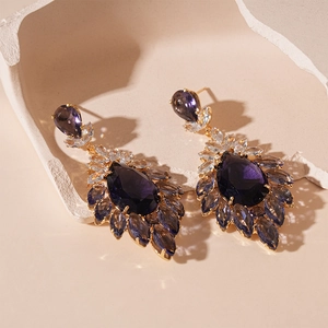 Vintage gold earrings with purple pear-shaped crystal drops and floral zirconia design