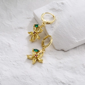 18K gold plated flower earrings with yellow and green zircon stones on white rock