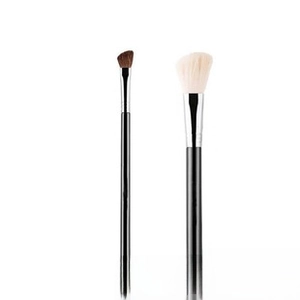 Detail of angled makeup brushes with brown synthetic bristles and black glossy handles