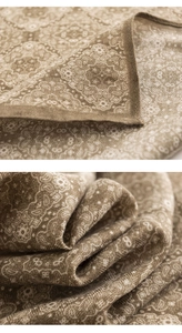 Detail of soft brown houndstooth and paisley silk-like scarf with elegant fabric texture