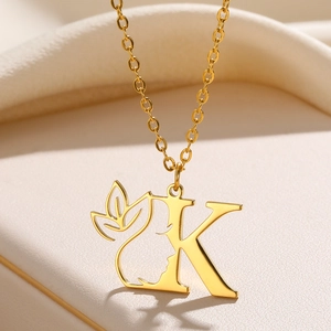 Golden stainless steel necklace featuring a letter K pendant with a female profile silhouette