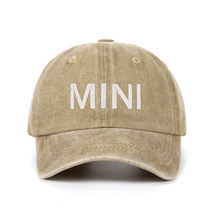 Close-up of MINI embroidery detail on a washed khaki cotton child baseball cap