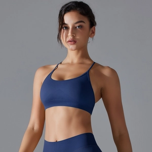 Detail of dark blue seamless sports bra with cross back straps and ribbed hem support