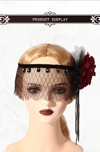 Detail of gothic black mesh veil with dark red rose and hanging black beads for parties