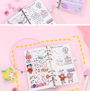 Macro view of clear loose-leaf notebook with cute decorative stationery on pink background