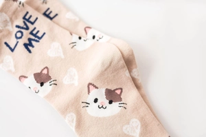 Detail of cotton crew socks featuring cute cat patterns and Love Me text embroidery