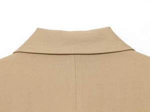 Detailed close-up of khaki blazer back seam and premium twill fabric texture