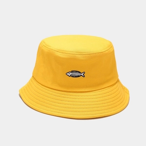 Detail of yellow canvas bucket hat featuring a fine black and white fishbone embroidery