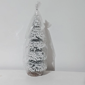Mini cedar Christmas tree with white flocking and burlap base in clear packaging