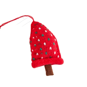 Knitted red Christmas tree ornament with white speckles and a brown trunk decoration
