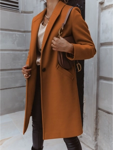 Close-up of caramel wool coat with lapel collar and stylish D-ring brown leather bag