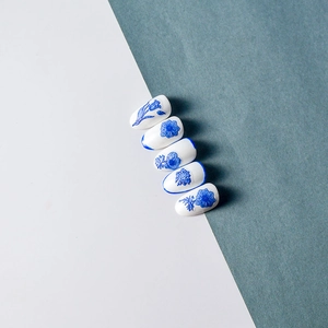 Detailed view of 5D Klein blue floral nail stickers with porcelain inspired patterns
