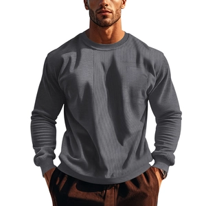 Detail shot of men's gray sweatshirt showing ribbed texture and chest pocket detail