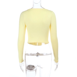 Back view detail of light yellow cropped knit top with ruffled lettuce edge hem
