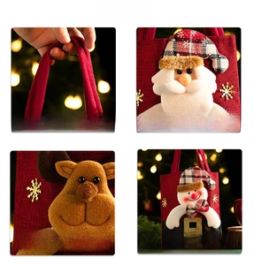 Detail of Christmas burlap gift bag with 3D Santa, reindeer designs and gold snowflakes