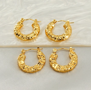 Detail shot of vintage 18K gold plated hoop earrings with unique hammered lava texture