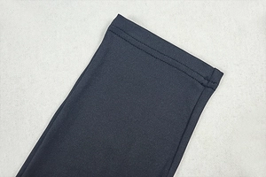 Detailed close-up of double-needle stitching on dark gray high-elastic knit fabric