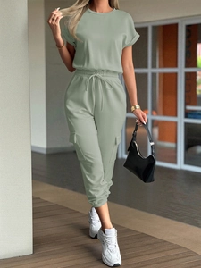Detail of grey-green casual short sleeve jumpsuit with cargo pockets and elastic drawstring