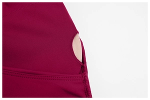 Detail view of removable pads and smooth stitching on dark red sports bra for workout