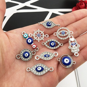 Macro view of evil eye charms in silver metal with rhinestones and colored inlay details